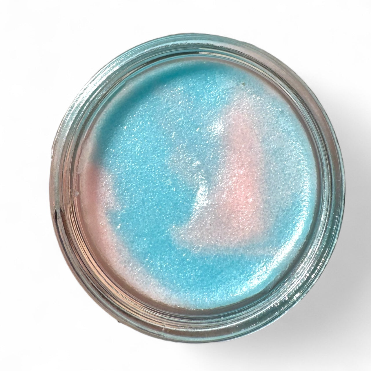 Jar of blue and pink sugar scrub that is scented like cotton candy.